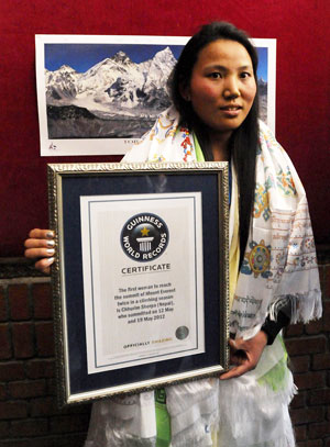 NEW WORLD RECORD: Chhurim Sherpa poses with her Guiness record certificate in Kathmandu. — AFP photo