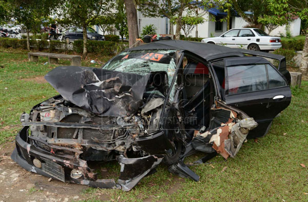 The damaged Proton Wira car that rammed into a tree in Lok Kawi.