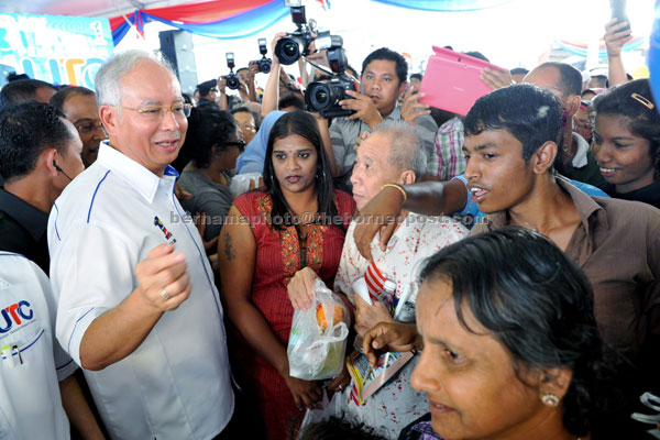 LIGHT MOMENT: Najib interacting with the general public at the launch of the Perak UTC. — Bernama photo