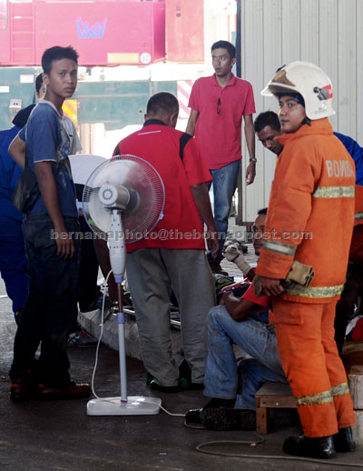 SERIOUSLY INJURED: Medical officers giving treatment to the victims after the collapse of the stadium roof. — Bernama photo