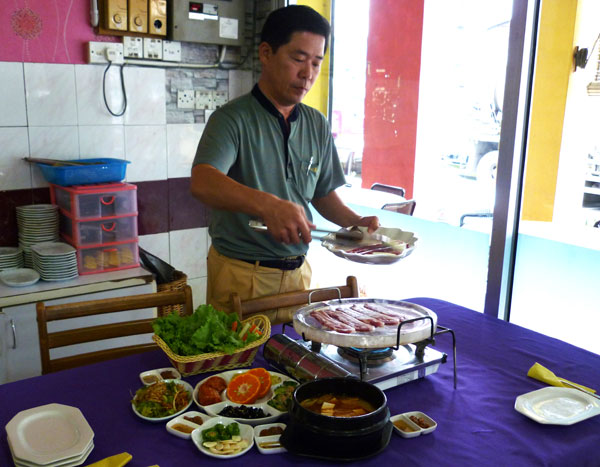 HEALTHY MEAL: Photo shows Seoul Garden proprietor, Steven Lee, demonstrating the method of grilling the meat on a crystal grill. 