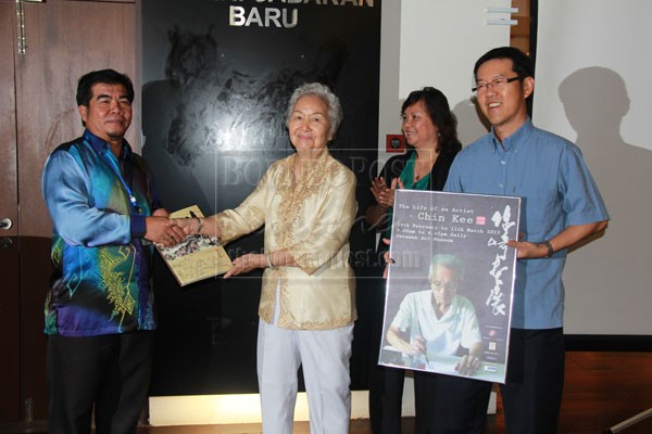 FOR YOU: Bong (second left) hands over a book as souvenir to Ipoi as Helen (second right) and Hong look on.