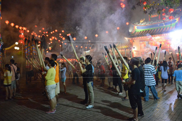 FAITH: As the smoke rises skyward, the wishes and prayers of the worshippers rise too. 