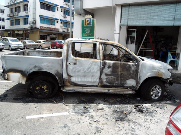  TOO LATE TO BE SALVAGED: The torched car.   