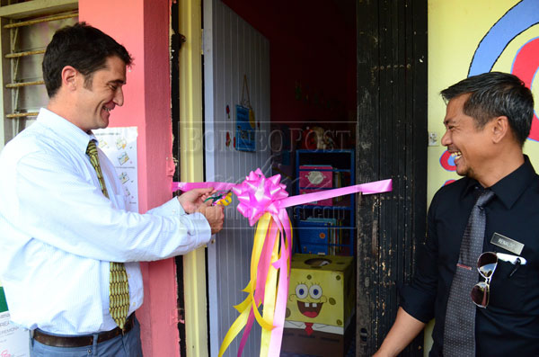 IT’S OPEN: Renaldo (right) and Williams open the newly decorated Power of Reading resource room.