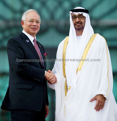 STRATEGIC PARTNERSHIP: Najib (left) shakes hands with Sheikh Mohammed after the welcoming ceremony in Putrajaya. — AFP photo