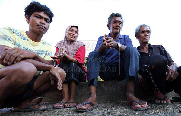 (Left to right) Roslan, Rahilah, Ahmad and Isnani walked for four hours after being stranded for 23 days in Kampung Tanjung Labian.