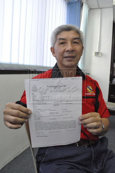 MISTAKEN IDENTITY: Jamalul showing the police report.