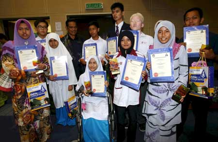 BEST IN STATE: Mohd Nor (third back left) with a group of high achievers (student with special abilities and orang Asli) at Johor education department. — Bernama photo