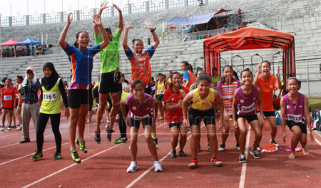 JUBILANT MOOD: SMK Tabuan Girls’ Under-14 and Under-15 team members in jubilant mood after winning the 4x100 and 4x400 relays at held Stadium Negeri yesterday. SMK Sukan Tabuan stole the limelight of the 49th Kuching MSSM Track and Field Championship after they defended their title for the fourth consecutive time.