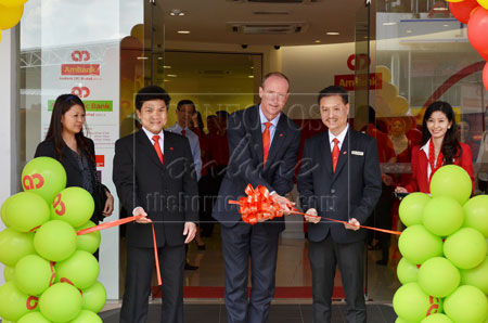 NEW VERSION:  Lewis (centre) cutting the ribbon to unveil the new concept branch at AmBank Jalan Abell branch here yesterday.