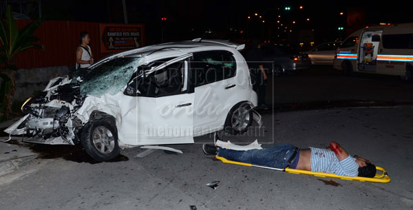 The victim and his car at the scene of the accident yesterday.