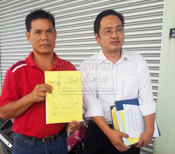 DISPUTING ARREARS: Lai (left) shows his claim at the Consumer Claims Tribunal. He is accompanied by his counsel Chong Chieng Jen. 