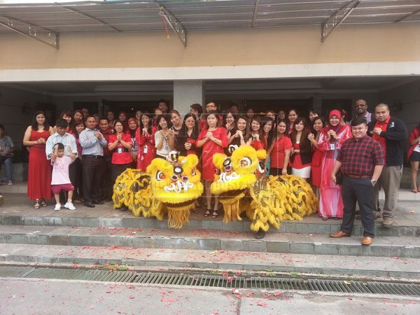 ALL THE BEST: Staff and students during a Chinese New Year celebration.