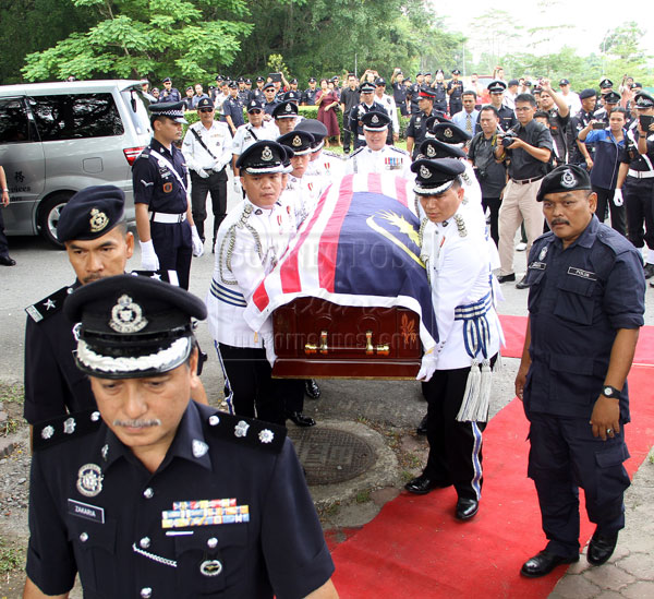 FINAL JOURNEY: The policemen in full ceremonial attire carrying the coffin to the Heroes Grave.