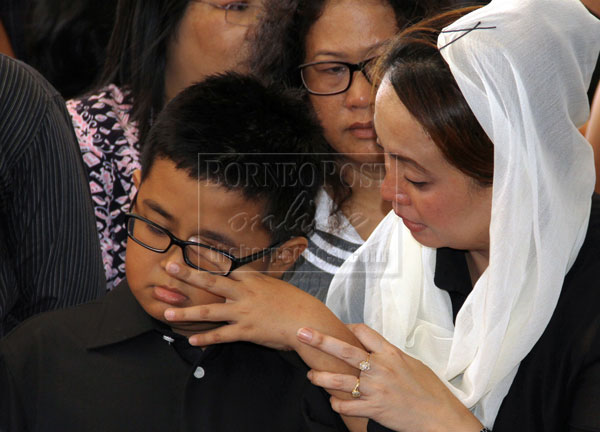 BE STRONG SON: Jabah consoles her son as her late husband is being laid to rest. - Photos by Chimon Upon