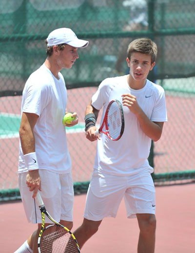 WINNING COMBINATION: Luke Bambridge of Great Britain (left) discusses game strategy with his Croatian partner Borna Coric during their boys doubles semi-finals match against the French pair of Ronan Joncour and Alexandre Muller yesterday. Bambridge-Coric won 7-6(2), 6-2 to enter the final. — Photos by Davidson Kho