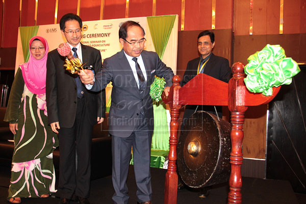 Yahya getting ready to beat a gong as a symbolic launch of the seminar.