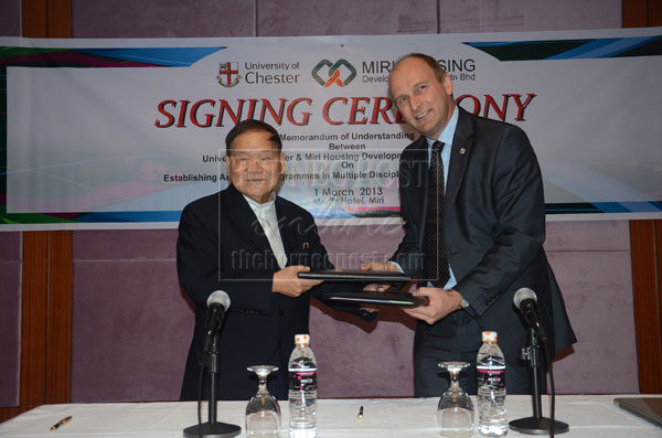 IT’S OFFICIAL: Lau (left) exchanges the MoU documents with Dr Haslam for the establishment of University of Chester campus in Senadin. 