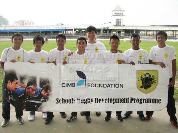 READY TO ROAR: The CIMB Foundation KRFU players together with their team manager, Azian Borhan (centre) who left for the Zahira Sevens Rugby in Sri Lanka yesterday posing for a group photo.