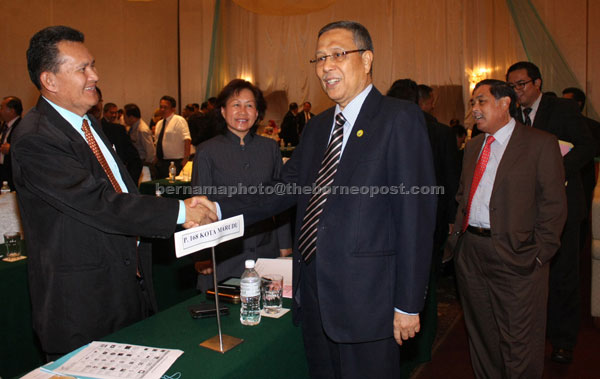 ELECTION BRIEFING: Abdul Aziz (right) shakes hands with an election officer after the briefing.