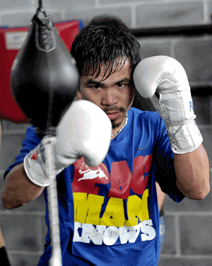 NOT IN USA: Pacquiao starts his first day training exercises at the summer capital Baguio City in the northern Philippines in this Sept 21, 2009 file photo. — AFP photo 