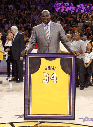 BIG SHOW: Former Los Angeles Lakers’ Shaquille O’Neal poses with his old jersey during a ceremony to retire jersey #34 in honor of O’Neal during halftime of the NBA basketball game against the Dallas Mavericks in Los Angeles. — Reuters photo