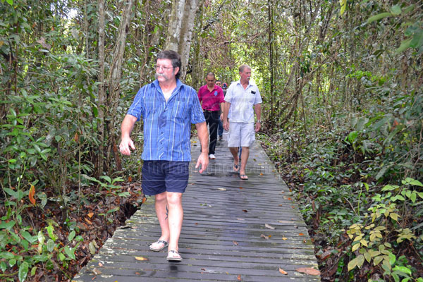 CAREFREE: Dr Morely (front) and Bob (right) enjoy the environment in Bukit Lima Forest Reserve.  
