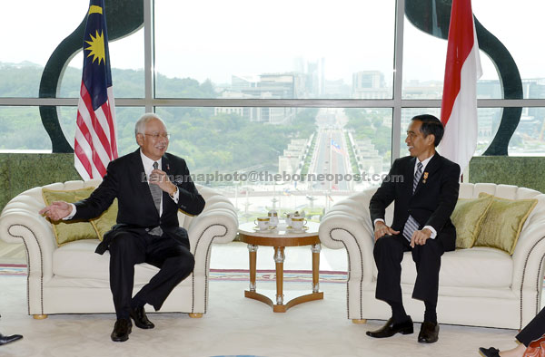 Najib (left) speaks with Joko Widodo during the Indonesian president’s visit to the Perdana Putra COmplex yesterday. — Bernama photo  