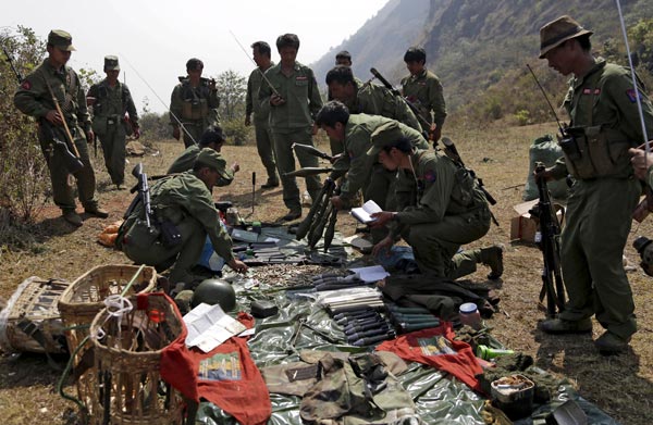 File picture shows rebel soldiers of the Myanmar National Democratic Alliance Army (MNDAA) examine weapons and ammunition at a military base in Kokang region.  — Reuters photo