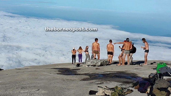 The tourists in the midst of undressing at the peak of Mt Kinabalu.