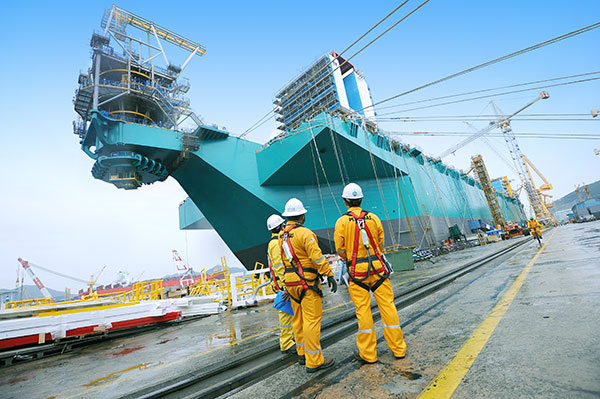 Photo shows Petronas employees observing the construction of PFLNG1. Although Petronas’ first PFLNG, the PFLNG1, is expected to start operations in the first quarter of next year, Adnan says the group has already received enquiries from multinationals.