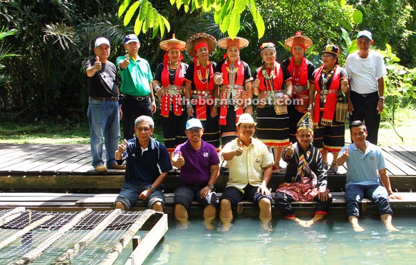 Ik Pahon (seated centre) soaking his feet in the hot spring after the gotong royong. 