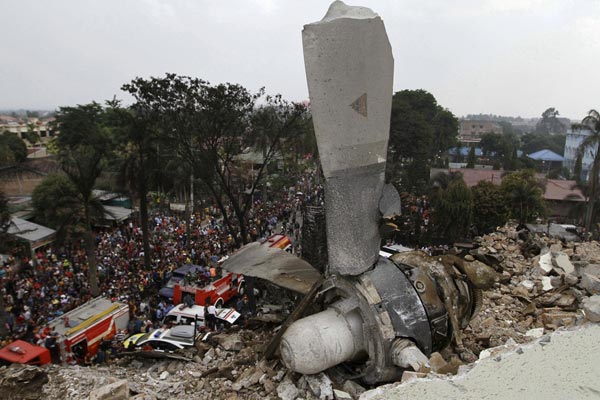 A propeller from the C-130 Hercules transport plane rests on the roof of a building. — Reuters photo