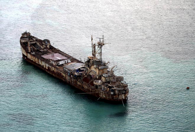 Filipino soldiers wave from the dilapidated Sierra Madre ship of the Philippine Navy as it is anchored near Ayungin shoal (Second Thomas Shoal) in the Spratly group of islands in the South China Sea, west of Palawan, Philippines, in this file photo. — Reuters photo