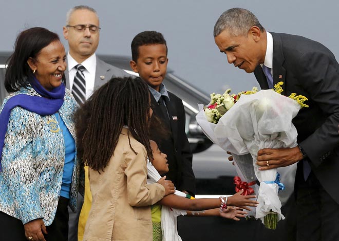 Obama receives flowers from children as he arrives aboard Air Force One at Bole International Airport in Addis Ababa, Ethiopia. — Reuters photo