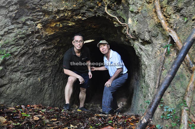 Architectural heritage writer Richard Nelson Sokial (left) and Victor Wong (right) standing at the mouth of the rediscovered Pinangsoo cave in Kudat.