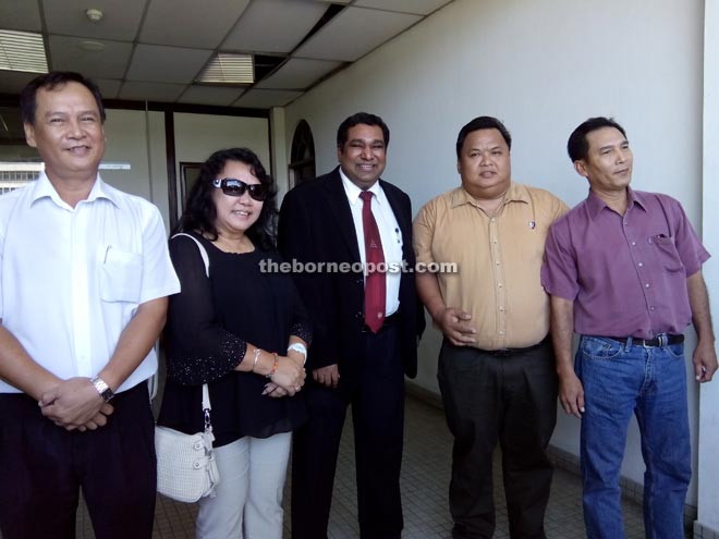 Levita and the Moikon brothers with defence counsel Zahir Shah (centre) outside the Sessions Court yesterday after being acquitted of their charges.