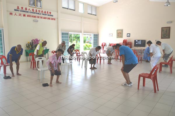 The senior citizens doing their Ba Duan Jin Qi Gong routine at the home.