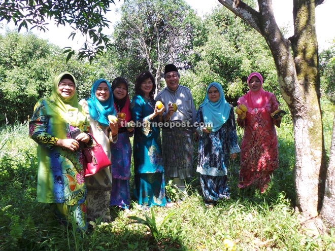 Awang Tengah (third right) and his wife Datuk Dayang Morliah Awang Daud (fourth left) are delighted to return to their roots as they can enjoy the fruits in their family orchard at Kampung Dato.