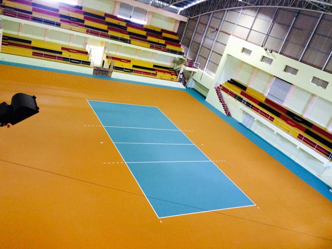 One of the two volleyball courts inside the stadium. In the background are the stadium seats.