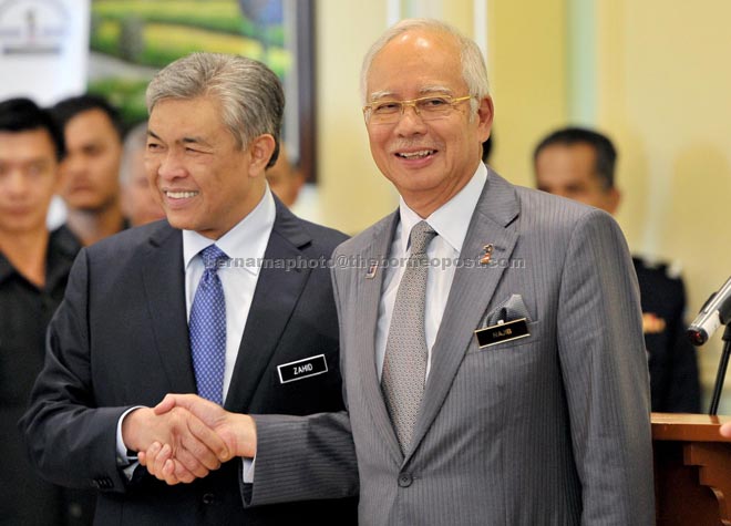 Najib shaking hands with Zahid Hamidi after the press conference at his office in Perdana Putra. — Bernama photo