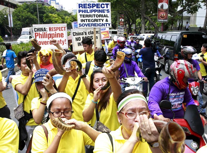 Protesters blow shofars during a rally regarding the disputed islands in the South China Sea, in front of the Chinese Consulate in Makati city, metro Manila. China called on the Philippines on Wednesday to withdraw a case it has filed at a UN arbitration tribunal over rival claims in the South China Sea and return to bilateral negotiations. — Reuters photo