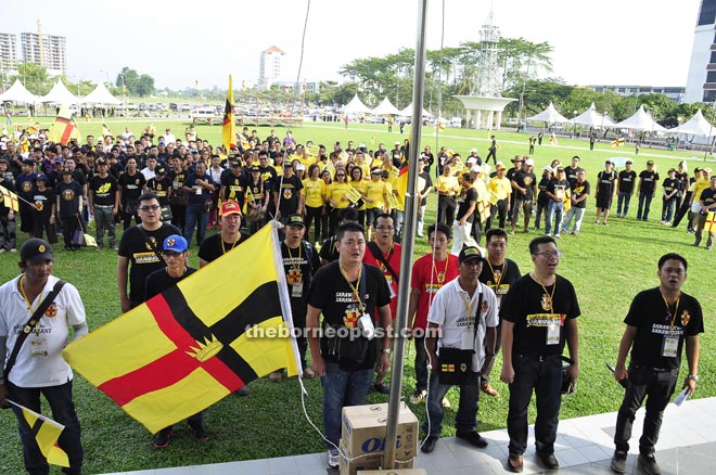 The participants singing the state anthem at the start of the programme at Sibu Town Square yesterday morning. Those wearing yellow T-shirts are SUPP members. 