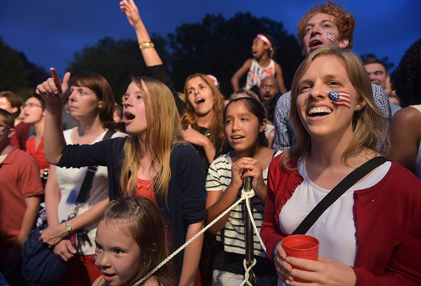 Revelers cheer while watching a performance by Bruno Mars during an Independence Day celebration for military members and their families on the South Lawn of the White House in Washington, DC. — AFP photo