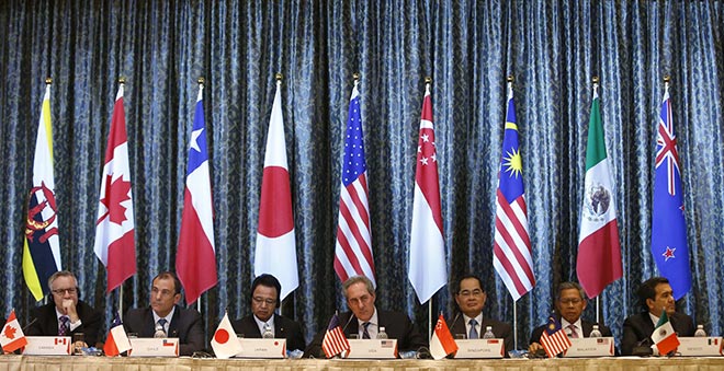 US Trade Representative Michael Froman (centre) speaks next to Japan’s Economics Minister Akira Amari (centre left) and Singapore’s Trade Minister Lim Hng Kiang (centre right), with Malaysia’s International Trade and Industry Minister Datuk Seri Mustapa Mohamed (second right) and other ministers representing Canada, Peru, and Mexico during a news conference at the end of a four-day TPP Ministerial meeting in Singapore held earlier this year. — Reuters photo 