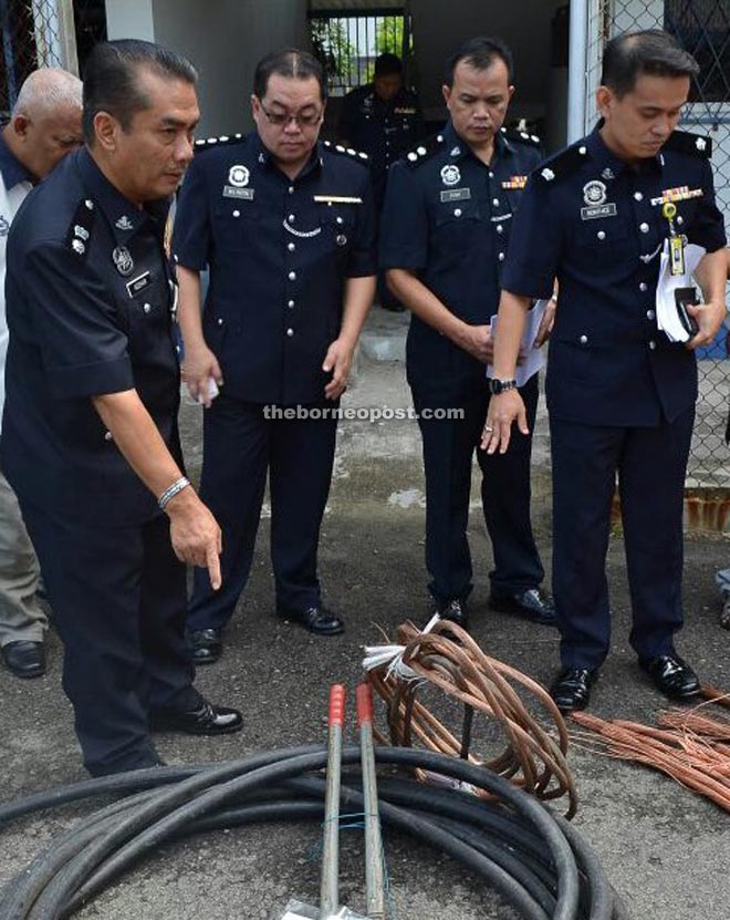 Adzhar (left) with other police officers from Crime Investigation Department showing the confiscated cable.