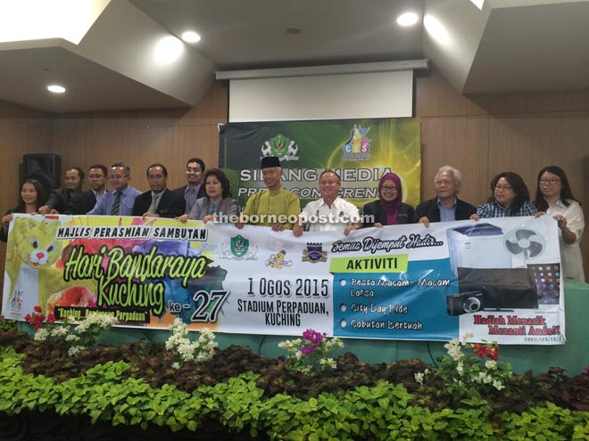 Abang Wahap (sixth right), with Chan on his left, show the banner on ‘Kuching City Day 2015’ with others after the press conference. 