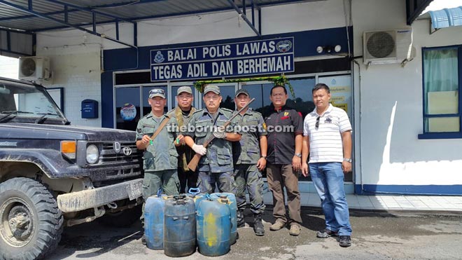 Paul (third left) and his men in a photo call with the confiscated items.