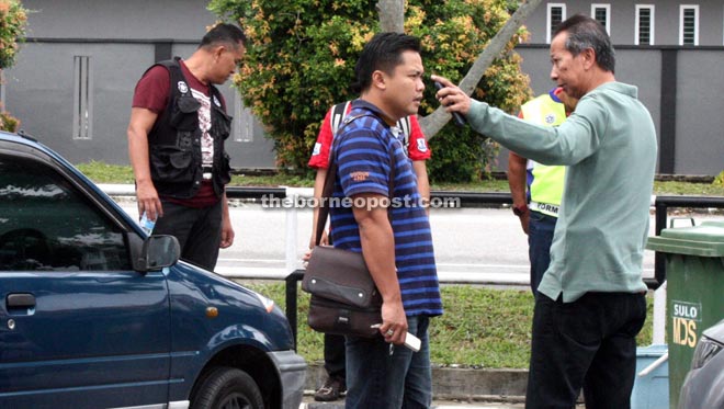 Sarifuddin (right) instructs his men at the crime scene.